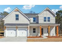 Charming two-story home with a painted brick facade and a two-car garage at 345 Orwell Dr, Social Circle, GA 30025