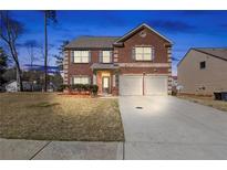 Charming two-story brick home features a two-car garage and well-maintained front lawn at 15 Mary Jane Ln, Covington, GA 30016