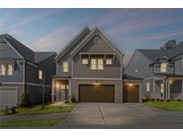 Charming two-story home featuring a two-car garage and a well-manicured lawn in a suburban setting at 837 Lakemont Dr, Canton, GA 30114