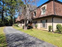 Charming townhomes featuring red roofs and private driveways, surrounded by lush trees at 2992 Parc Lorraine, Lithonia, GA 30038