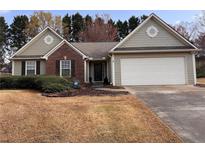 Charming single-story home with a two-car garage and well-maintained front lawn at 1850 Westwind Dr, Cumming, GA 30041