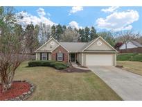 Charming one-story home featuring a brick facade, attached garage, and well-maintained landscaping at 1850 Westwind Dr, Cumming, GA 30041