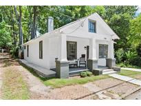Charming craftsman-style home with white siding, a cozy front porch, and lush landscaping at 370 Sydney Se St, Atlanta, GA 30312