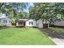 Well-maintained home with a green lawn and mature trees, providing great curb appeal at 1377 Marston St, Smyrna, GA 30080
