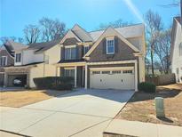 Charming two-story brick home with a two-car garage and well-maintained landscaping at 2478 Brynfield Cv, Suwanee, GA 30024