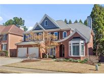 Beautiful two-story brick home with a manicured lawn and attached two car garage at 3311 Fieldwood Se Dr, Smyrna, GA 30080