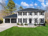 Charming two-story home featuring a three-car garage and a well-maintained lawn at 4833 Glenwhite Dr, Duluth, GA 30096