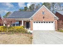 Charming brick home with a two-car garage, inviting front yard, and a well-maintained lawn at 499 Bellbrook Ln, Lawrenceville, GA 30045