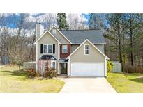 Charming two-story home featuring a two-car garage and a well-maintained front yard with mature trees at 3045 Arden Ridge Dr, Suwanee, GA 30024