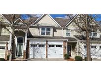 Charming townhome featuring a two-car garage and traditional architectural details at 3512 Clear Creek Crossing, Kennesaw, GA 30144