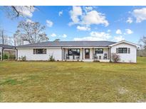Beautiful single story home with a metal roof and a spacious front yard at 4739 Lower Jersey Rd, Oxford, GA 30054