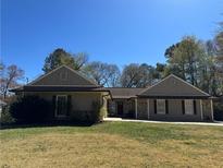 Charming single-story home featuring stone accents, neutral siding, a well-maintained lawn, and a classic design at 2894 Dellinger Dr, Marietta, GA 30062