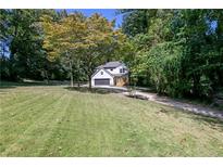 Charming new construction home featuring a spacious yard and tree-lined surroundings at 2143 Lyle Ave, College Park, GA 30337