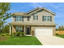 Charming two-story home with a well-manicured lawn and inviting covered front porch at 4825 Layton Drive, Lithia Springs, GA 30122