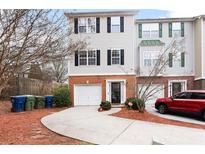 Charming townhome with attached garage and well-manicured front yard at 700 Celeste Sw Ln, Atlanta, GA 30331