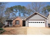Charming single-story home with brick and siding and an attached two car garage at 985 Orchard Mill Ct, Lawrenceville, GA 30043