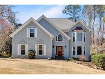 Charming home with a well-manicured lawn, light gray exterior, and inviting front entrance at 3623 Summerford Dr, Marietta, GA 30062