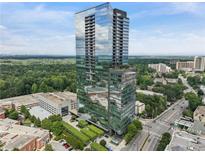 Stunning high-rise condo building with glass facade, lush landscaping, and a desirable urban location at 3630 Peachtree Ne Rd # 3302, Atlanta, GA 30326