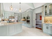 Bright kitchen featuring stainless steel appliances, a center island, and stylish pendant lighting at 3720 Harts Pl, Atlanta, GA 30341