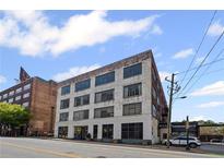Exterior shot of a multi-story brick building featuring large windows and street-level commercial spaces at 434 Marietta Nw St # 205, Atlanta, GA 30313