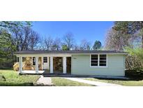 Charming single-story home with a stone facade porch and a well-maintained lawn at 6886 Upshaw Mill Rd, Douglasville, GA 30134