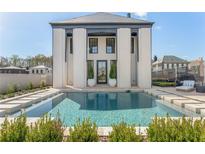 Stunning backyard pool with modern design and elegant landscaping, perfect for relaxation and entertainment at 245 Roycroft Ln, Fayetteville, GA 30214