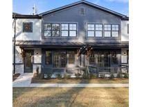 Charming townhome featuring a modern facade and well-manicured lawn at 937 Willingham Dr # 7, Hapeville, GA 30354