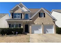 Charming two-story brick home featuring a two-car garage and well-maintained landscaping at 1295 Leisure Lake Dr, Lawrenceville, GA 30044