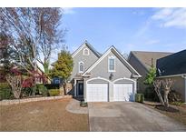 Charming two-story home featuring a well-manicured front yard, double garage, and classic architectural details at 1920 Rosebriar Dr, Marietta, GA 30066