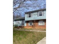 Charming exterior view of a light blue and red brick split-level home with a well-maintained front yard at 5626 Pine Gate Dr, Atlanta, GA 30349