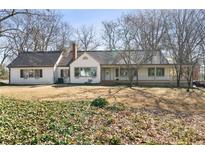 Charming single-story home featuring a covered front porch and mature trees on a spacious lot at 1140 Goodwin Ne Pl, Atlanta, GA 30319
