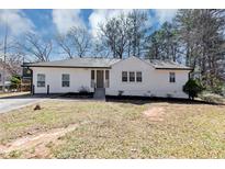 Charming, freshly painted home with a manicured lawn and mature trees offering great curb appeal at 381 Warner Se, Marietta, GA 30060