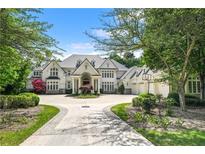 Stunning traditional home with circular driveway, manicured landscaping and attached three car garage at 510 Covington Cv, Alpharetta, GA 30022