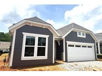 Charming home showcasing stylish gray siding, crisp white trim, and an attached two-car garage at 188 Balsam Dr, Dallas, GA 30157