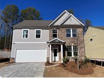 Charming two-story home featuring a brick and gray siding exterior and a two-car garage at 4300 Easter Lily Ave Lot 11, Buford, GA 30519