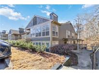 Inviting condo showcasing a blend of shingle and siding exterior and a staircase leading up to the front entrance at 2006 Riverview Dr, Marietta, GA 30067