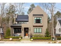 Charming two-story home with modern design, manicured landscaping, and inviting front porch at 321 Mado Ln, Chattahoochee Hills, GA 30268