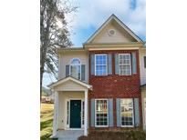 Charming two-story home featuring a brick facade, teal shutters, and a well-maintained front yard at 20 Pine Canyon Sw Dr # 15, Atlanta, GA 30331