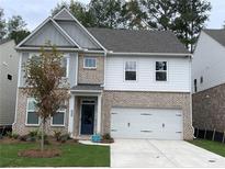 Charming two-story home featuring brick accents, gray siding, and a convenient two-car garage at 4375 Easter Lily Ave Lot 81, Buford, GA 30519