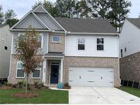 Beautiful brick and siding two-story home with a well-maintained lawn and a two-car garage at 4375 Easter Lily Ave Lot 81, Buford, GA 30519