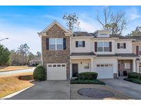 Charming townhome with a stone facade, a one-car garage, and manicured landscaping at 258 Ridge Mill Dr, Acworth, GA 30102