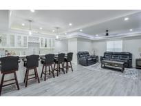 Finished basement featuring a sleek bar area with modern cabinets and a comfortable seating area at 3570 Mill Creek Drive Sw Dr, Smyrna, GA 30082