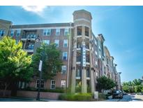 Low-angle view of a multi-story condo building with a sign reading 