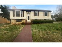 Charming home featuring stone accents and lush landscaping at 4933 Bayside Ct, Stone Mountain, GA 30088