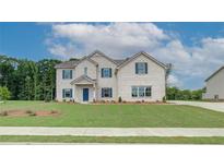 Beautiful two-story white brick home with a manicured lawn and a welcoming blue front door at 193 Haverling Pass, Hampton, GA 30228