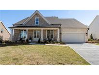 Charming single-Gathering home with a covered front porch and a well-manicured lawn at 5120 Token Chase, Cumming, GA 30040