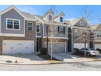 Charming townhome featuring a two-car garage and a welcoming exterior at 1530 Redbud Way, Tucker, GA 30083