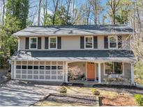 Charming two-story home with a two-car garage and landscaped front yard at 330 Knoll Woods Dr, Roswell, GA 30075