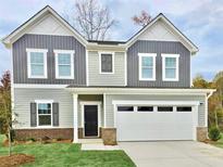 Charming two-story home featuring a two-car garage, black front door, and a well-manicured front lawn at 163 Sonoma Drive, Dallas, GA 30157