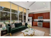 Bright living room featuring floor-to-ceiling windows and an open concept kitchen with stainless steel appliances at 3400 Malone Dr # 110, Atlanta, GA 30341